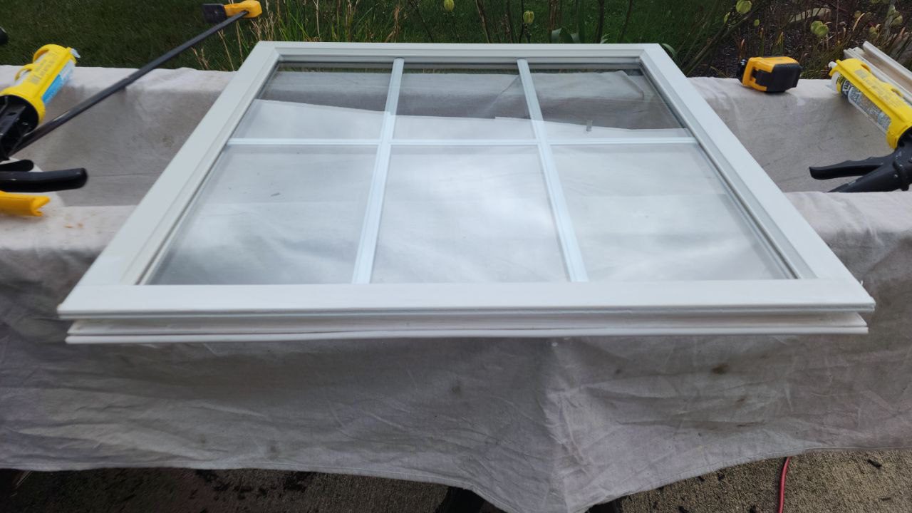 White vinyl window sash with divided glass panes during residential window repair and restoration