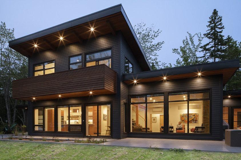 Modern two-story house with large glass windows, showcasing high-quality window installation