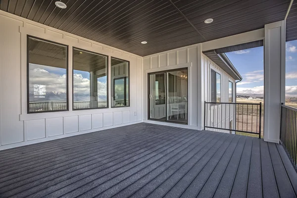 Modern home with large black-framed picture windows and sliding glass doors